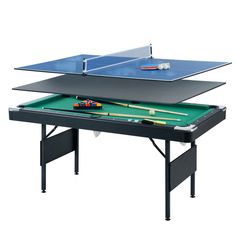 the ping pong table is set up with pool cues and billiards on it