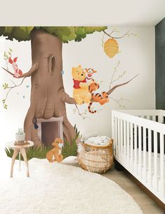 a baby's room with winnie the pooh mural