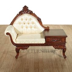 an antique style couch and coffee table on the floor