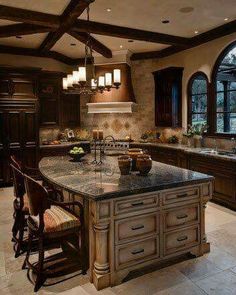 a large kitchen with an island in the middle