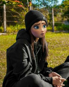 a person sitting on the ground wearing a beanie and looking at something with blue eyes