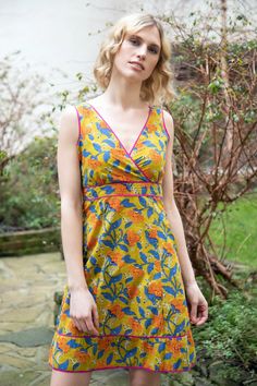 This beautiful short cotton sun dress is perfect for your summer wardrobe. The marigold yellow and blue floral print on natural block print fabric is both eye-catching and versatile. The dress features a flattering v-neckline and sleeveless design, with a hidden side zip for easy wear. The fitted waist creates a feminine silhouette, while the sweetheart neckline and cap sleeves add a touch of elegance. Perfect for a summer day out or a casual garden party, this dress is both beautiful and comfor Cotton Sleeveless V-neck Dress For Beach, Yellow Cotton Sleeveless Summer Dress, Yellow Fitted Sleeveless Cotton Dress, Fitted Sleeveless Yellow Cotton Dress, Summer Sleeveless V-neck Cotton Dress, Cotton V-neck Sleeveless Sundress, Yellow V-neck Sundress For Garden Party, Yellow Cotton Sleeveless Vacation Dress, Yellow Cotton A-line Sundress