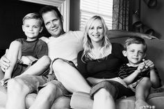 black and white photograph of family sitting on couch