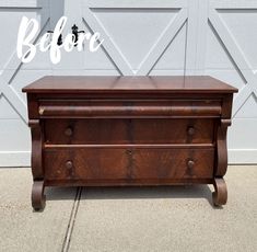 a wooden chest with the word before painted on it's side in front of a garage door