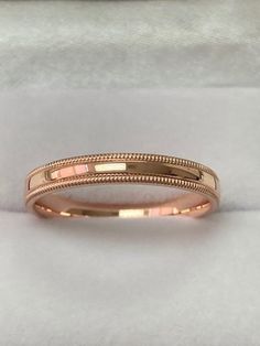 a gold wedding band with two lines on it