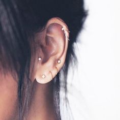 a woman with ear piercings on top of her head and an instagram page below