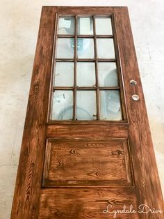 a wooden door with glass panes on the bottom and side panels inlays