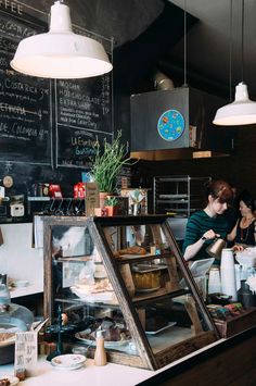 a woman working behind the counter at a cafe