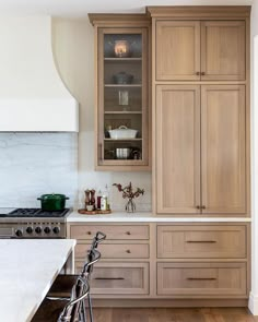 a kitchen with wooden cabinets and white marble counter tops, along with a bicycle parked in front of the cabinet