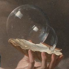 a close up of a person holding a bubble