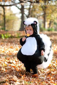 a small child dressed in a costume eating something