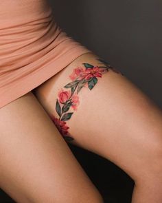 a woman's thigh with flowers painted on it