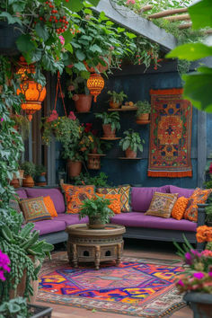 an outdoor living room with potted plants and rugs