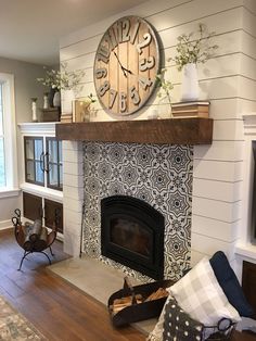 a living room with a fireplace and a large clock on the wall above it's mantle