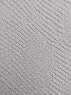 a white snake skin textured up to the surface