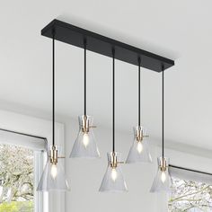 a kitchen light with five lights hanging from the ceiling