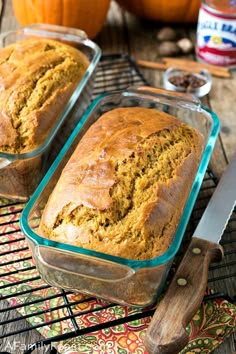 two loafs of pumpkin bread sitting on top of a cooling rack