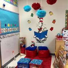 the cat in the hat themed classroom is decorated with red, blue and green pom poms