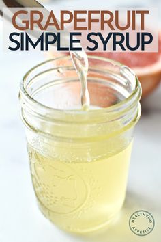 grapefruit simple syrup is poured into a mason jar