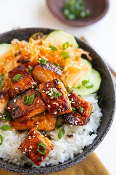 a bowl filled with rice and meat on top of a table