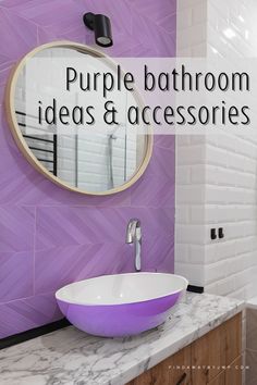 a bathroom with purple and white tiles on the walls, a round mirror above the sink