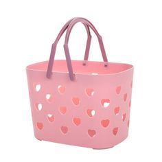 a pink bag with hearts cut out on the side and handles, sitting in front of a white background