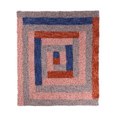 an orange, blue and pink rug with squares on it's sides is shown