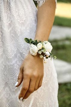 a close up of a person wearing a bracelet with flowers on it's wrist