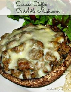 sausage stuffed potato mushroom on a plate with rice and lettuce next to it