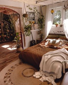 a bedroom with a bed, rugs and plants