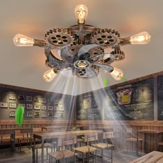 an industrial style light fixture hangs from the ceiling in a restaurant with wooden tables and benches