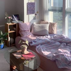 a living room with a couch, coffee table and large windows looking out onto the city