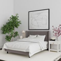 a bedroom with a bed, nightstand and potted plant on the side table in front of it