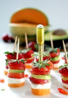 small appetizers with toothpicks and vegetables on them are ready to be eaten