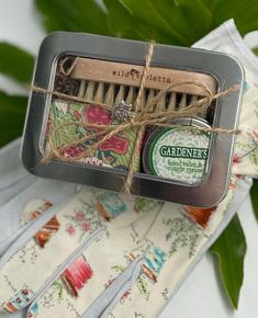 "A cute and thoughtful Christmas gift for Gardeners, our Gardening gift tin is a sweet little gift to show you care.  A darling gift for Gardeners who love to toil in the earth's soil.  Gardening Gift Set Includes: + 1 ounce Gardener's Healing Balm and Cuticle Cream + 2.5 ounce bar organic eucalyptus and tea tree soap + Natural two sided nail brush + Packaged in a 5\" x 4\" x 1.5\" window tin ideal for storing seeds, tags and twine. The gardener's gift tin is wrapped with twine and keepsake silver garden snail charm GARDENER'S BALM -  https://www.etsy.com/listing/125124678 Our natural Garden Healing hand balm and cuticle cream is made with organic Shea butter, hazel nut oil and a warming blend of essential oils. This is a remarkable blend which is effective for gardeners and hard working h Storing Seeds, Cuticle Repair, Gardening Gift Set, Tea Tree Soap, Tree Soap, Snails In Garden, Healing Tea, Cuticle Cream, Wood Nails