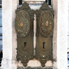 two ornate door handles on an old building