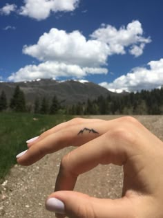 The 90 Most Popular Symbols For Travel Tattoos | Unique & Cute Travel Tattoo Ideas Moutain Tattoos Finger, Small Bear And Mountain Tattoo, Mountain Peak Tattoo Simple, Glacier National Park Mountain Tattoo, Mountain Finger Tattoo Simple, Mountain Tattoo Behind Ear, Finger Tattoos Mountain, Mountain Tattoo On Finger, Finger Mountain Tattoo