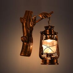 a light that is on the wall next to a hand holding a lamp fixture with it's arm