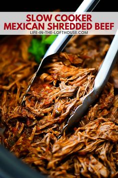 two tongs sticking out of shredded meat in a bowl