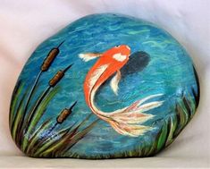 a painted rock with an image of a fish in the water