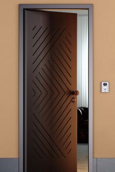 an open door in a room with a brown wall and carpeted flooring on the ground