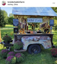 an old farm stand with flowers and vegetables on display