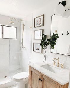 a bathroom with white walls and wooden cabinets