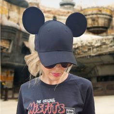 Our Classic Mouse Ear Hat is perfect for a day spent in the Disney parks or out around town. This hat is made of 100% high quality cotton to be both lightweight and durable. It features two premium black mouse ears made to stand up... even on the wildest rides! Details: ONE SIZE FITS MOST ADULTS: Ball cap features an adjustable metal slider on the back of the hat to allow for easy resizing for a snug and comfortable fit 100% COTTON excluding decoration: Adjustable hat is composed of lightweight and durable cotton fabric, and features a curved brim for protection from the sun. SPOT TREAT ONLY: Recommended for spot treatment only. Lay flat to dry. Do not iron decoration. Sun Spot, Ear Hat, Black Mouse, Ponytail Hat, Iron Decoration, High Ponytails, Ear Hats, Mouse Ears, Ball Cap