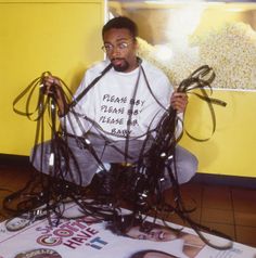 a man sitting on the floor with many wires in front of him and his face