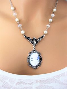 "Classic Victorian Lady Cameo Necklace handmade by Ralston Originals. Click to see all the colors. These cameo necklaces are made with Victorian lady face cameos, in your choice colors; blue, dark blue, black, brown, purple, pink, or dark pink cameos. The cameo is in a beautiful ornate antique silver setting, then attached to a unique antique silver connector that really sets off the importance of the cameo. Followed by the classic Victorian look with white pearl beads, and sparkling clear cryst Elegant Cameo Necklaces For Wedding, Elegant Cameo Necklace For Wedding, Cameo Pendant Necklace For Wedding, Bohemian Cameo Necklace For Gift, Titanic Ii, Antique Cameo Jewelry, Lady Face, Beautiful Beaded Jewelry, Cameo Pendant Necklace