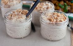 three jars filled with oatmeal sitting on top of a table next to other food