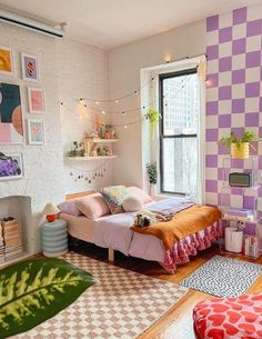 a bedroom decorated in pastel colors and patterned walls