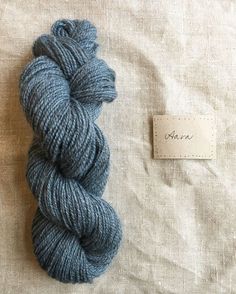 a skein of blue yarn next to a tag