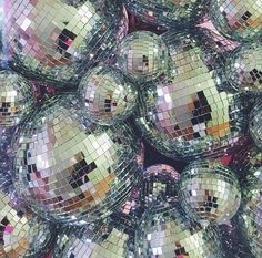 many shiny disco balls are stacked together